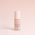 A bottle of Transforma AHA serum 30ml product against a pink background.